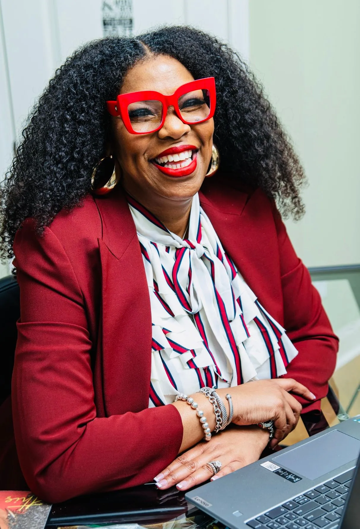 Dr. Z smiling in red glasses